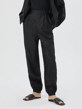 a woman in xiangyun silk pants